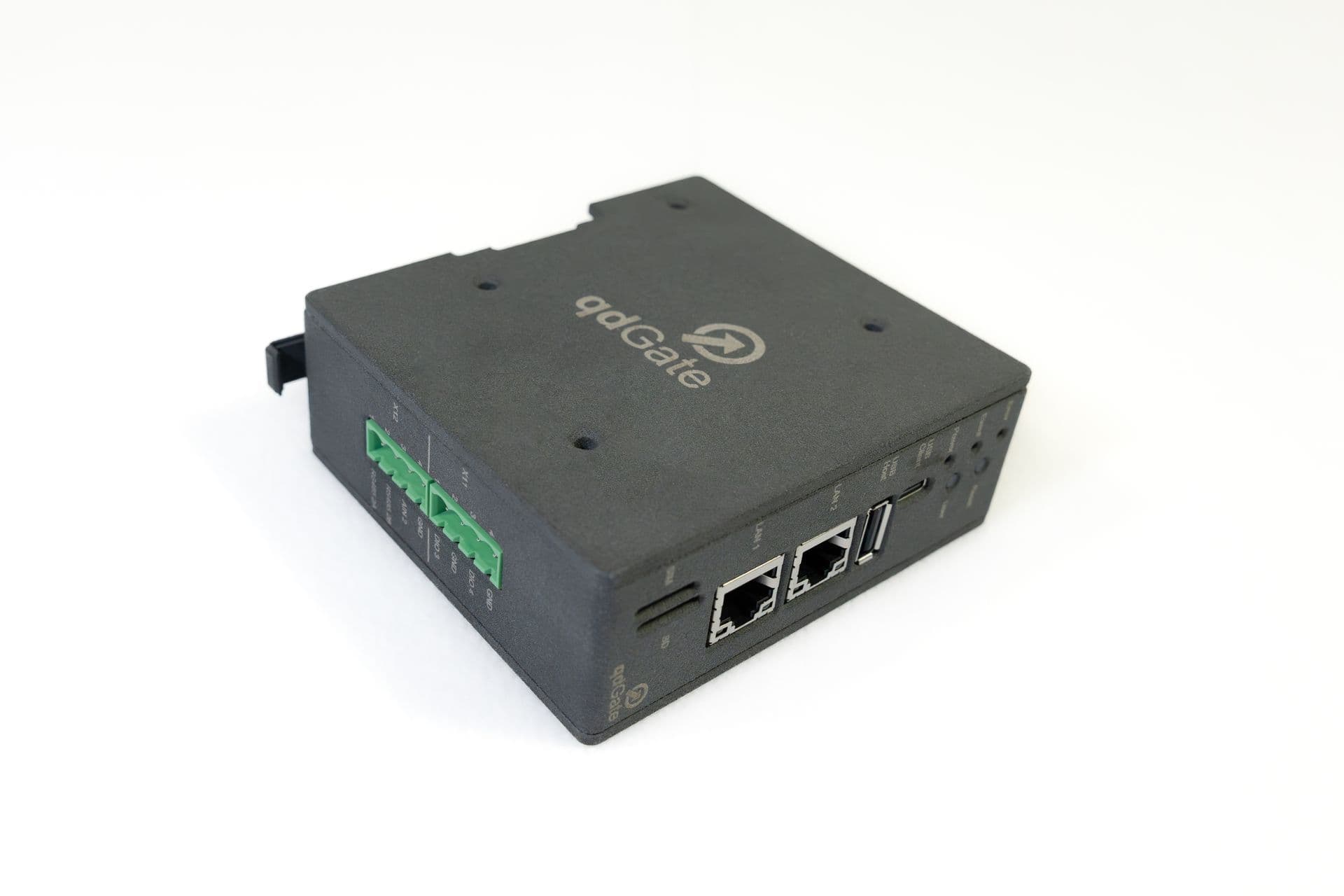 qdGate in its closed black housing with the logo on the lid, green plug-in terminals on the side, two LAN sockets and USB at the front